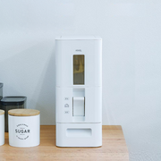 White kitchen storage container with a digital display on a wooden surface.