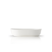 A single Adam Liaw Everyday Noritake oval serving bowl in white porcelain, viewed from the side against a white background.
