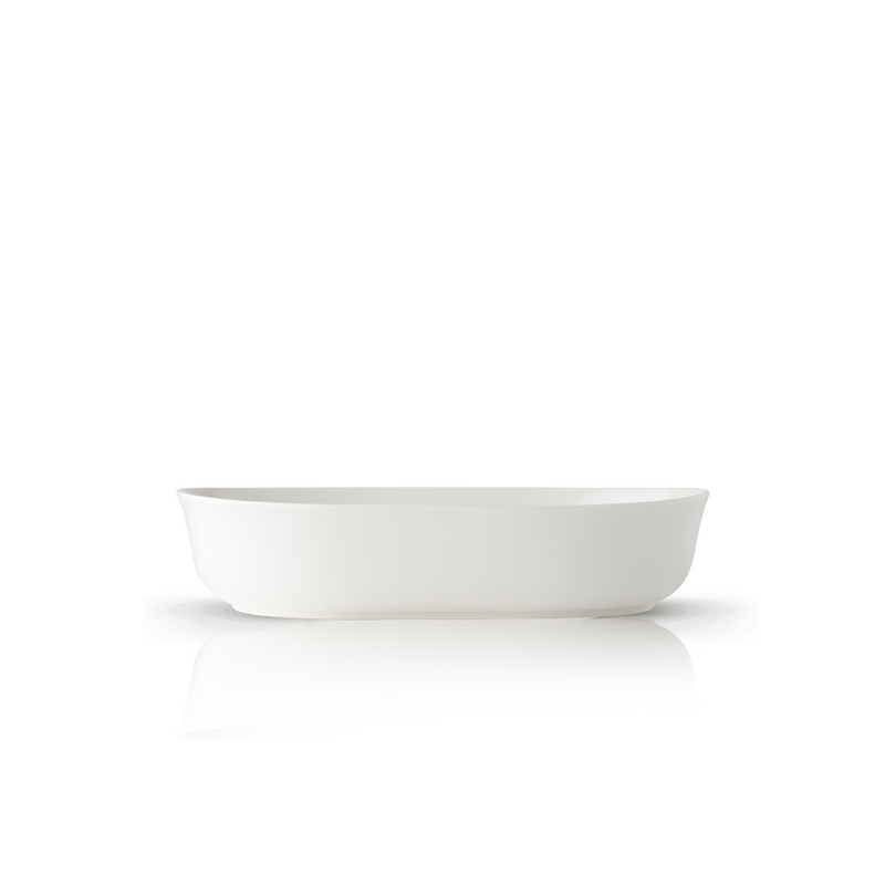 A single Adam Liaw Everyday Noritake oval serving bowl in white porcelain, viewed from the side against a white background.
