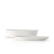 The Adam Liaw Everyday Noritake oval serving set, including a 24cm white porcelain bowl and a 26cm white porcelain platter, shown together against a white background.
