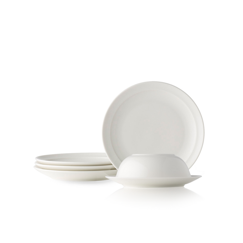 The Adam Liaw Everyday Noritake small plate and bowl set. The image shows a white porcelain bowl stacked upside down on a plate, with other plates stacked and displayed nearby, against a white background.
