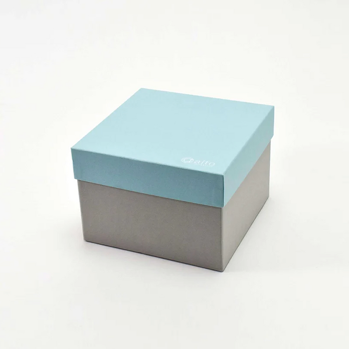 A square-shaped box with a turquoise lid and a grey bottom, bearing the brand "Aito."