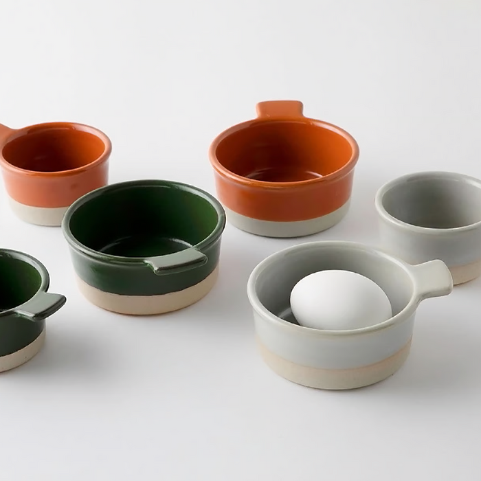 Small bisque ceramic bowl, perfect for serving sides or individual portions.