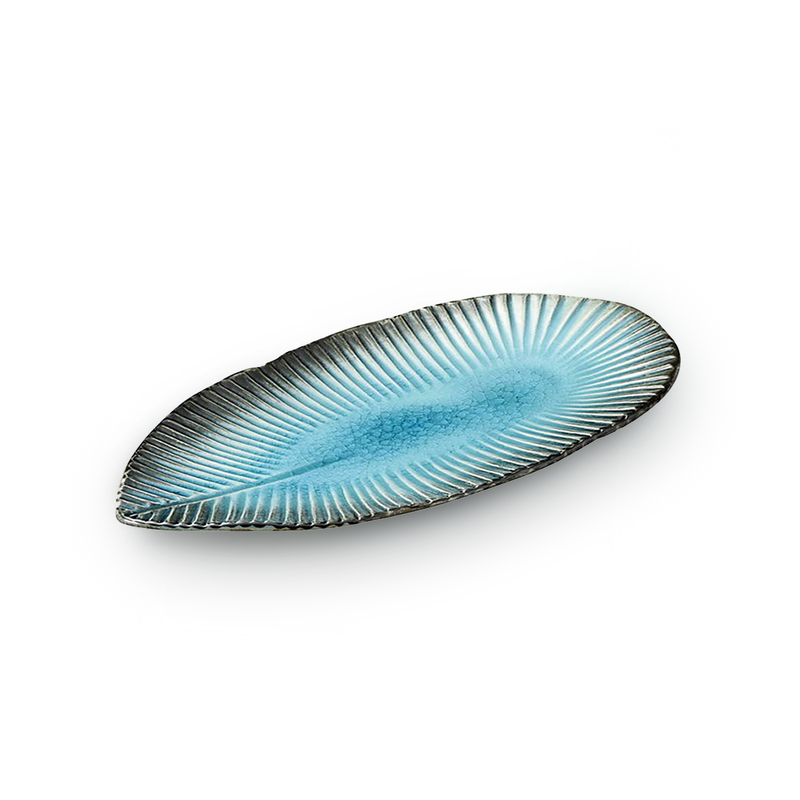 A top-down view of the Aizome Blue Sky serving plate, showing its leaf shape with a light blue center and dark radiating lines that resemble veins.