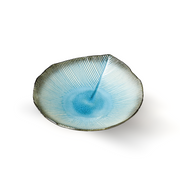 A top-down view of the Aizome Blue Sky serving plate, showing its textured leaf shape with a light blue center and dark, radiating veins.

