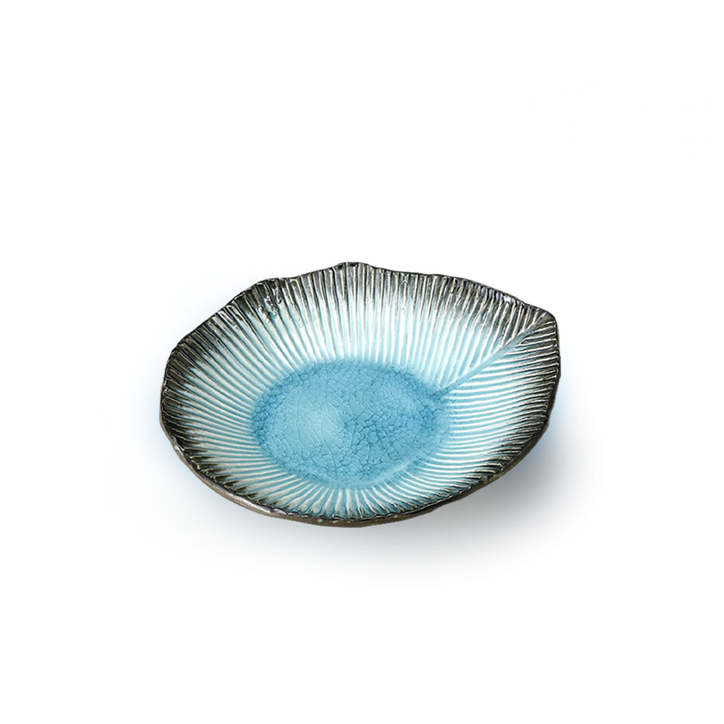 A top-down view of the Aizome Blue Sky Side Plate, showing its unique leaf shape and serene blue glaze.