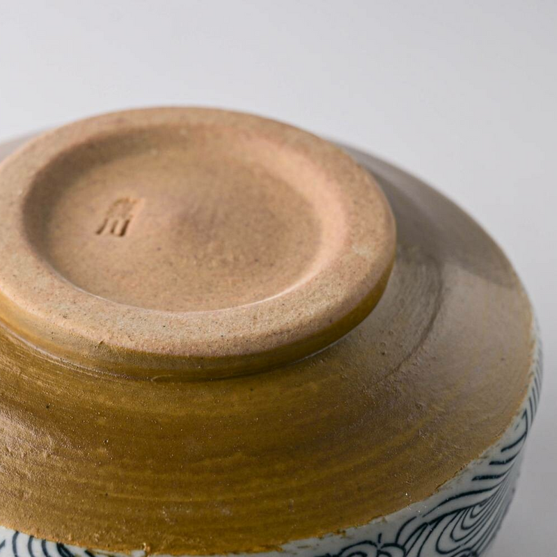 The unglazed foot (kōdai) of the Arahami matcha bowl, with a small maker's mark stamped into the clay.