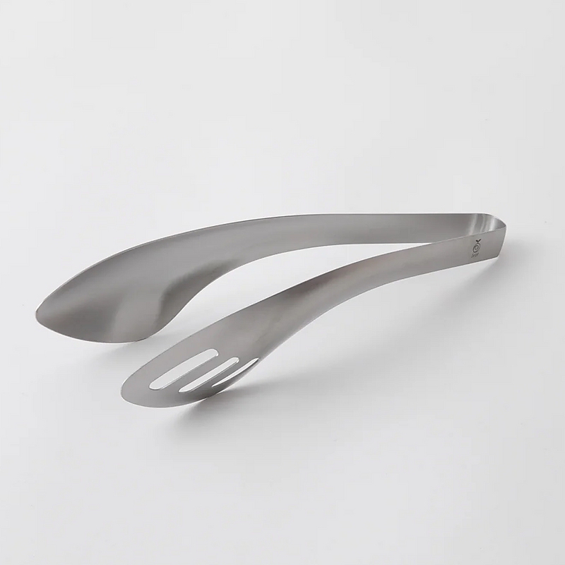 Close-up view of the Aux Leye stainless steel tongs, highlighting the purposeful hole feature.