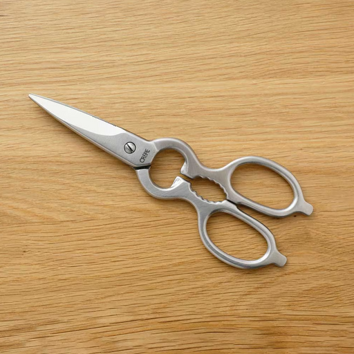 The Banshu Hamono handmade Japanese kitchen scissors, forged from a single piece of stainless steel, shown on a plain white background.
