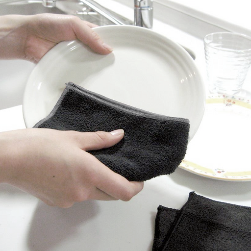 Bistro Master Multi-Purpose Antibacterial Cleaning Cloth being used to dry a white ceramic plate over a kitchen sink.