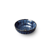 A top-down view of the Yohenkon Ten Grass Chrysanthemum Bowl, showing its flower shape, radiant blue 'Ten Grass' pattern, and unique kiln-altered glaze.