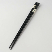 Close-up detail of the decorative band on the Japanese chopsticks, showing the blue karakusa pattern in a painterly style.