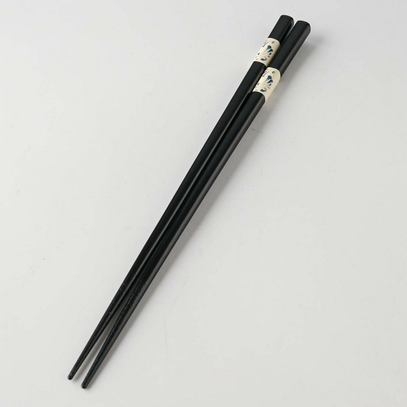 Close-up detail of the decorative band on the Japanese chopsticks, showing the blue karakusa pattern in a painterly style.