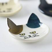 Japanese cat cutlery rest on white background, emphasising the vibrant blue and gold ear details
