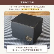 Black gift box with a logo on a striped fabric background