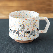 A white CHIPS stackable mug featuring colourful splashes and a whimsical black line drawing of a bear and rabbit holding mushrooms, part of the Mori no Kinoko Club collection.