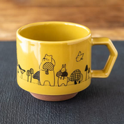 A yellow CHIPS stackable mug featuring a whimsical black line drawing of a bear and rabbit holding mushrooms, part of the Mori no Kinoko Club collection.