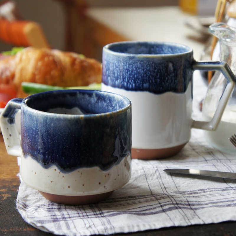 Two CHIPS Stack Mugs in different sizes on a breakfast table, showing how they can be used as a set.