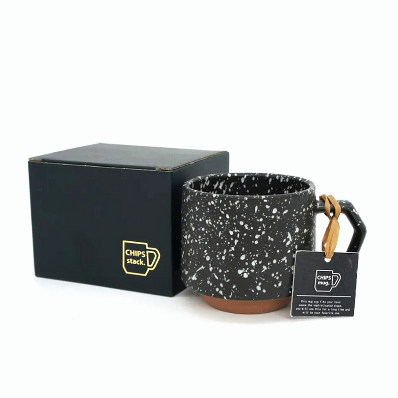 The 280ml CHIPS Stack Mug in Splash Black White shown next to its elegant black gift box.
