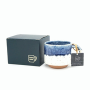 The 280ml CHIPS Stack Mug in White Navy Drop shown next to its elegant black gift box, with a branded tag on the handle.