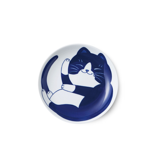 A white ceramic dinner plate featuring a hand-painted illustration of a happy, contented cat in deep indigo, curled up in a relaxed pose.