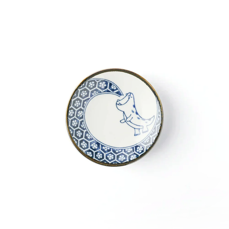 The Edokko Dinosaur Flame Dragon Mini Plate in blue, showing the dinosaur illustration against a hexagonal patterned background.
