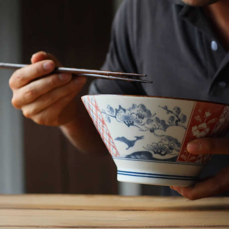 Close-up of the Edokko Dinosaur Donburi Bowl highlighting a delicate plum blossom and bird design in blue and red with subtle geometric accents.