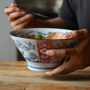 Edokko Dinosaur Donburi Bowl filled with ramen noodles, pork slices, and spring onions, showcasing detailed Edo-inspired patterns.