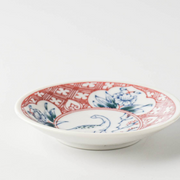 Side profile of the Edokko Dinosaur Hanaryu mini plate, highlighting its shallow curved rim and white porcelain body.