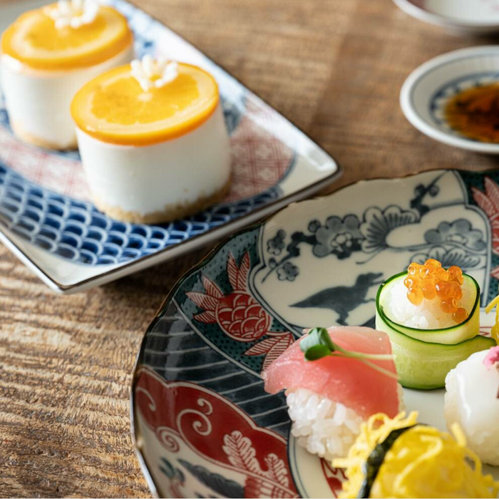 Edokko Dinosaur Rectangular Serving Plate used alongside other Japanese tableware, displaying a vibrant dining presentation.