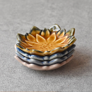 Four Fiore Dahlia mini plates in different colours stacked together to show their shape and profile.

