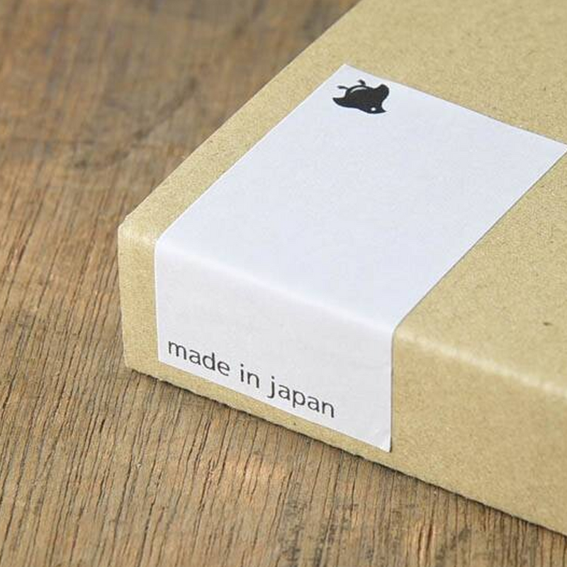 A close-up of the kraft gift box with a minimalist white label reading made in japan, emphasising the product’s Japanese origin





