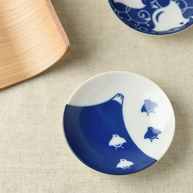 The underside of multiple side plates featuring a blue chidori zukushi Japan logo, highlighting the brand detail and smooth porcelain finish
