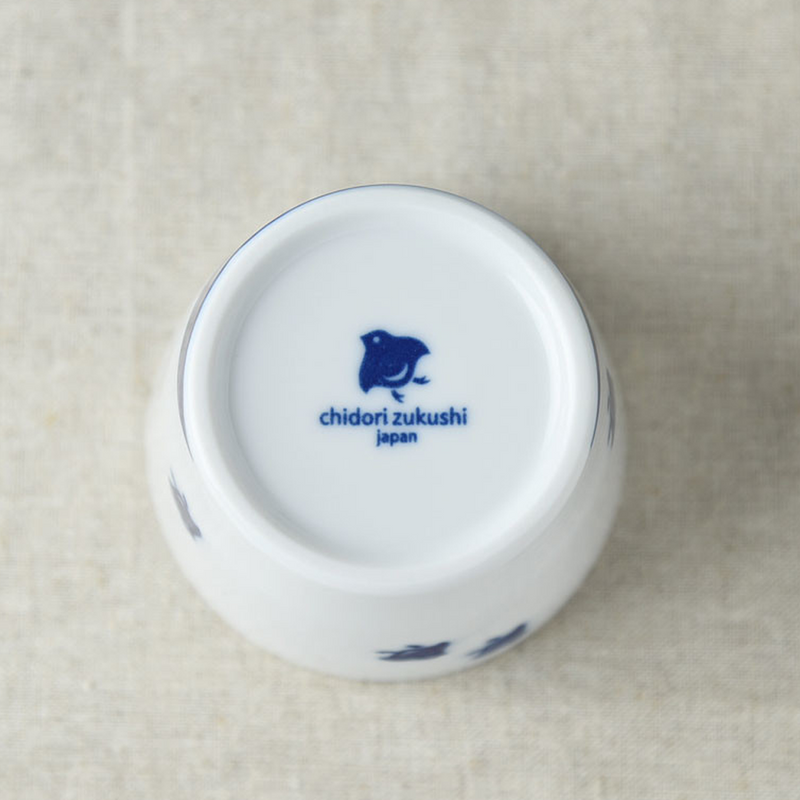 Bottom view of a white ceramic cup, showcasing the manufacturer's mark "chidori zukushi japan" in blue on its base.