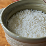 A close-up view inside the Ginpo donabe, showing the texture of freshly cooked, fluffy white rice.

