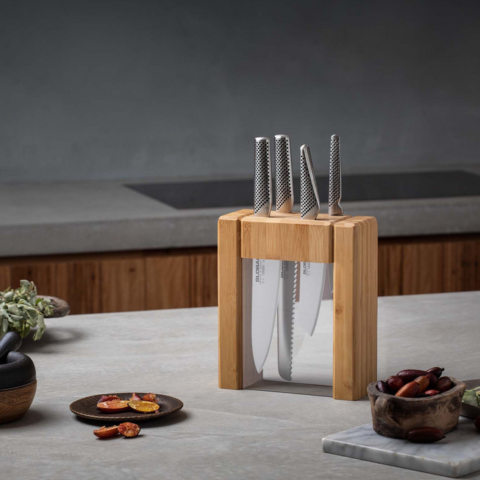 Global Ikasu 5-Piece Knife Block Set on a kitchen countertop, with a modern kitchen backdrop.