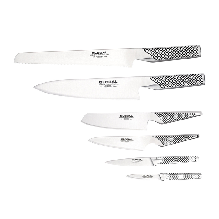 Global Ikasu 7-piece knife set displayed against a white background, featuring six knives and a bamboo knife block