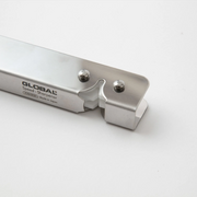 A detailed shot of the Global knife sharpener's ceramic wheels and stainless steel body.