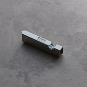 The stainless steel Global Speed Sharpener resting on a dark, textured surface.