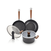 The 5-piece Happycall Crocodile Graphene nonstick induction cookware set, including a frypan, wok, pot, and two glass lids, featuring wood-style handles and hexagonal patterned surfaces.
