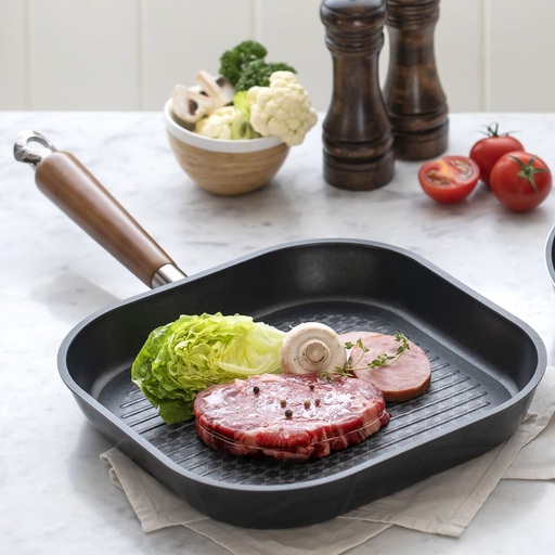 The 28cm square Happycall Crocodile Graphene nonstick induction grill pan, showing its raised grilling ridges and wood-style handle, angled on a white background.
