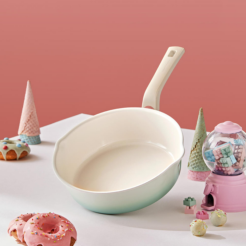 The 22cm Happycall Flex 3-in-1 ceramic nonstick induction saucepan, showing its mint green gradient exterior, ivory interior, and dual pouring spouts.