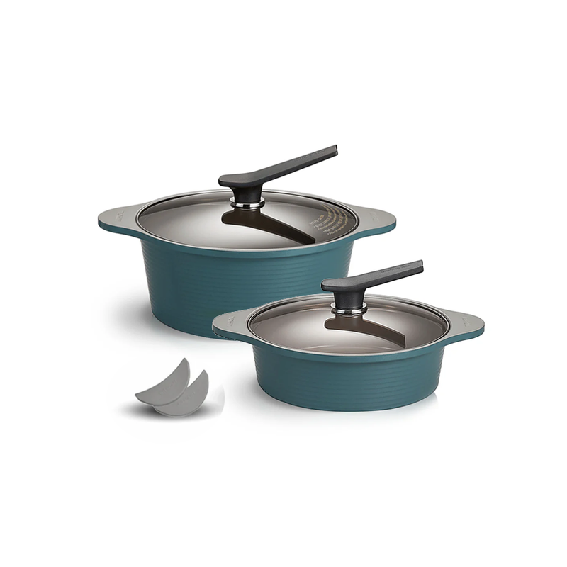 The Happycall Onde ceramic nonstick induction pot set in an ocean green finish, showing the 28cm stockpot, the low 24cm pot, and a pair of silicone pot holders.
