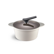 The 24cm Happycall Onde ceramic nonstick induction pot in an ivory finish, shown with its self-standing tinted glass lid and featuring a ridged exterior.
