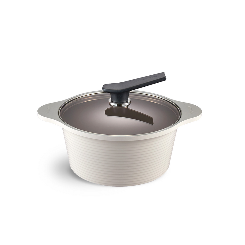 The 24cm Happycall Onde ceramic nonstick induction pot in an ivory finish, shown with its self-standing tinted glass lid and featuring a ridged exterior.
