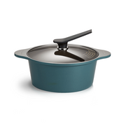 The 28cm Happycall Onde ceramic nonstick induction stockpot in an ocean green finish, shown with its self-standing tinted glass lid and featuring a ridged exterior.
