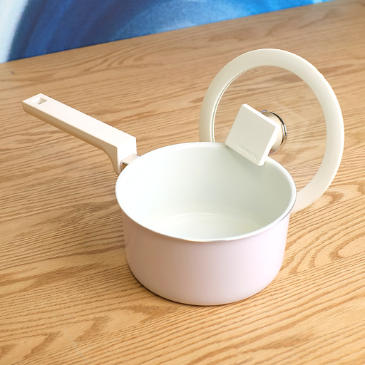 The 16cm Happycall Meister Edge ceramic nonstick induction saucepan in a pastel lavender finish, shown with its matching glass lid and modern grey handle.
