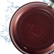 Bottom view of the Happycall Solrais Diamond Wok in maroon, highlighting induction-compatible base with splash effect.







