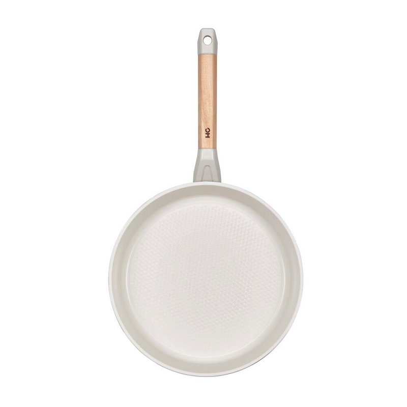 Side profile of the Happycall Sonora 26cm frypan featuring a white ceramic body and wooden handle.
