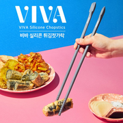 Hand using Happycall VIVA Silicone Chopsticks to lift tempura on a pink and blue background, showcasing their non-slip grip.

